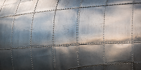Riveted aluminum aircraft skin showing rows of flush rivets.