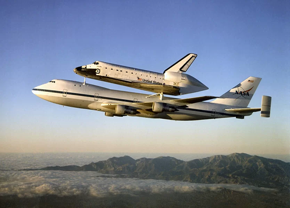 Shuttle carrier aircraft lifting the space shuttle.